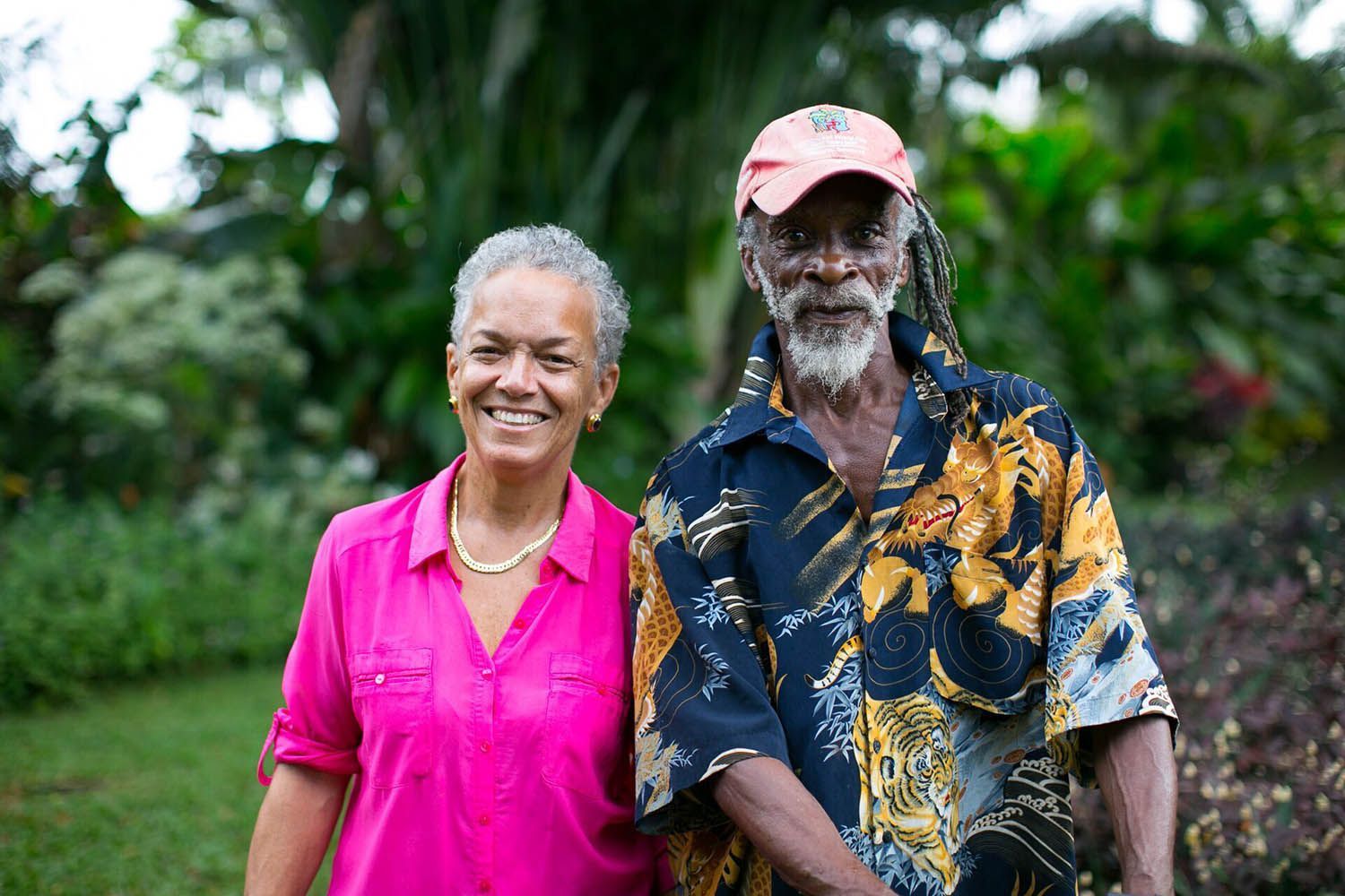 A man and a woman are standing next to each other in a park.