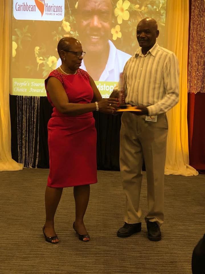 A woman in a red dress is shaking hands with a man