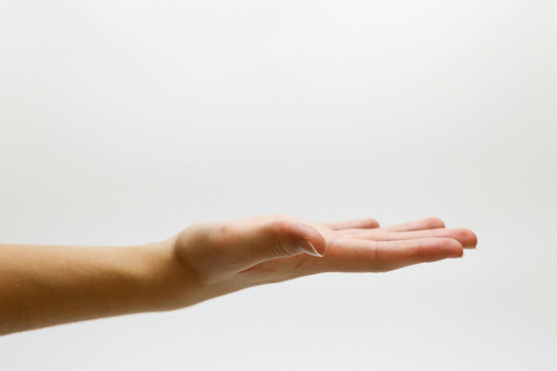 A close up of a person 's hand on a white background.
