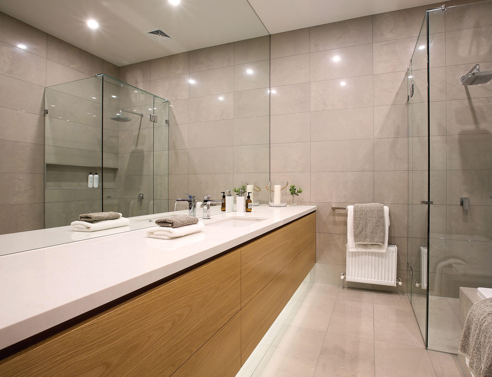 A bathroom with two sinks and a walk in shower — Glass Replacements in Rockhampton, QLD