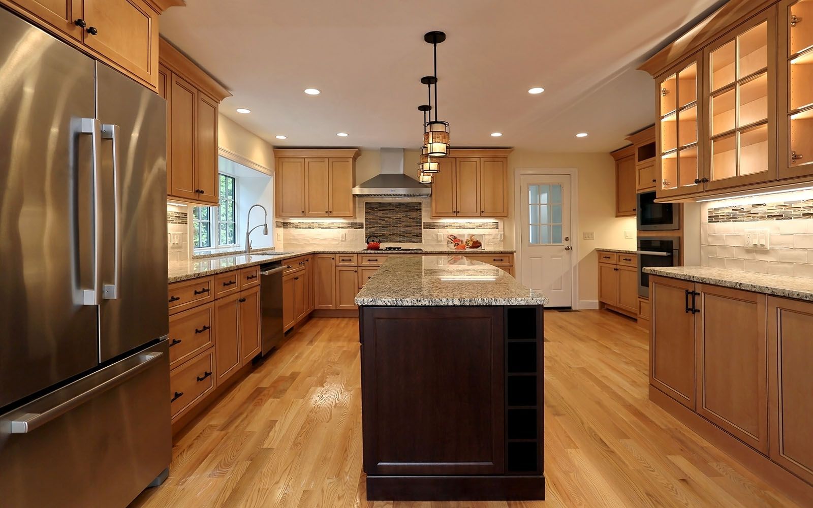 Spacious kitchen with wood cabinets, island, stainless steel appliances, and granite countertops.
