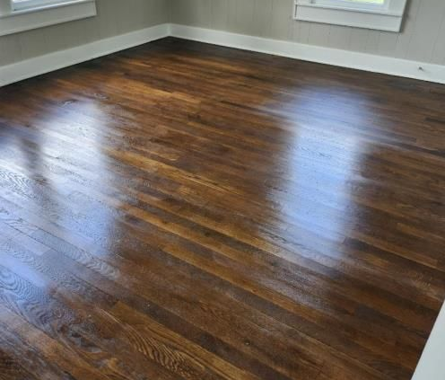 a living room with a couch , chair , coffee table and plant .