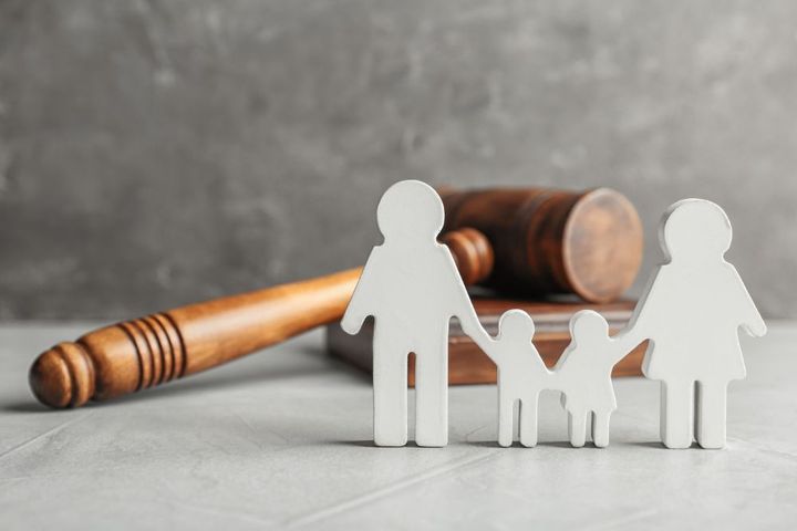 Paper cutout of family with gavel