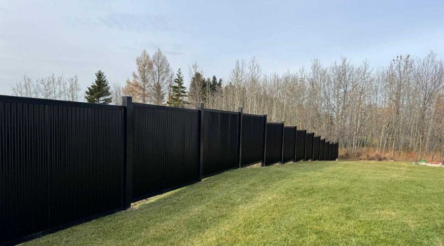 Black hurricane-ready privacy fence installed around a backyard