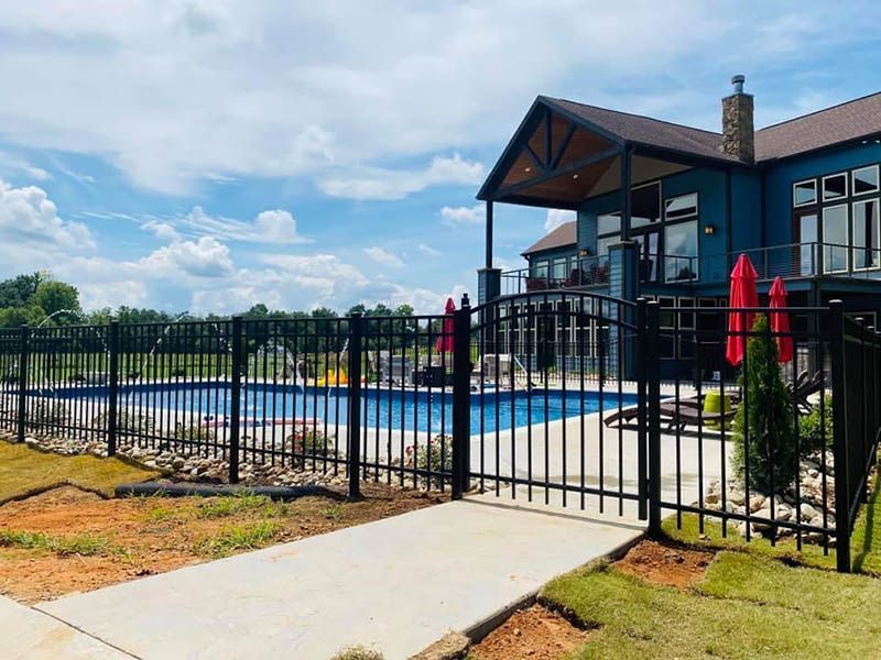Aluminum installation in Ozark, Missouri with sleek black pickets, secure pool perimeter, and clean modern lines.