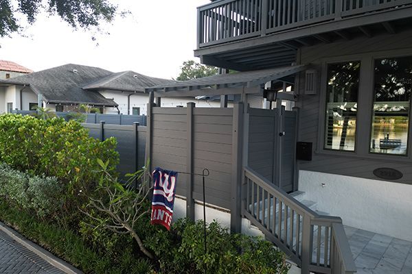 A house with a fence and a sign that says play on it
