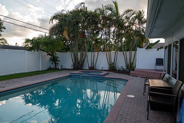 A large swimming pool in the backyard of a house