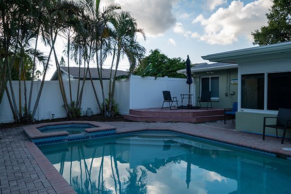 A large swimming pool in the backyard of a house