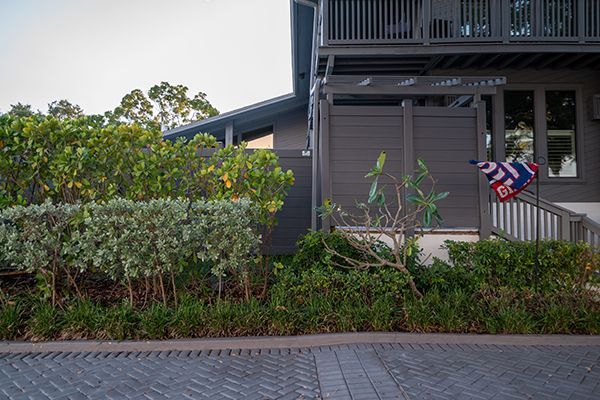A house with a fence and a flag in front of it.