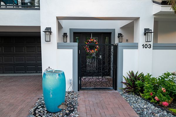 The front of a house with a blue vase in front of it.