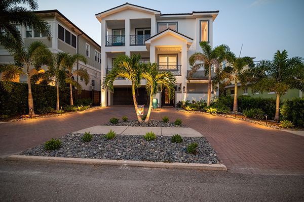A large white house with palm trees in front of it