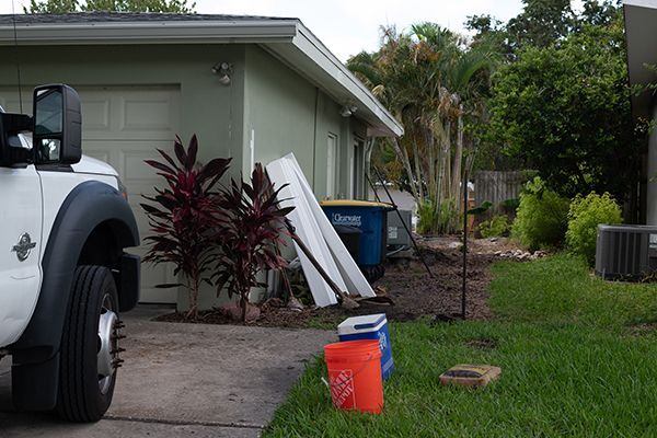 A white truck is parked in front of a house.