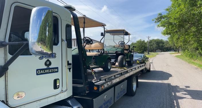 golf carts on tow truck