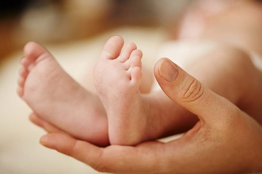 overnight infant support feet parent hand