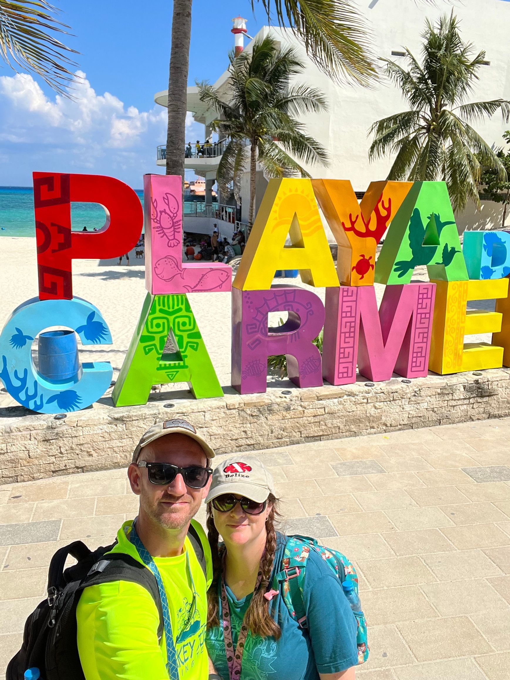 Couple posing in front of colorful 