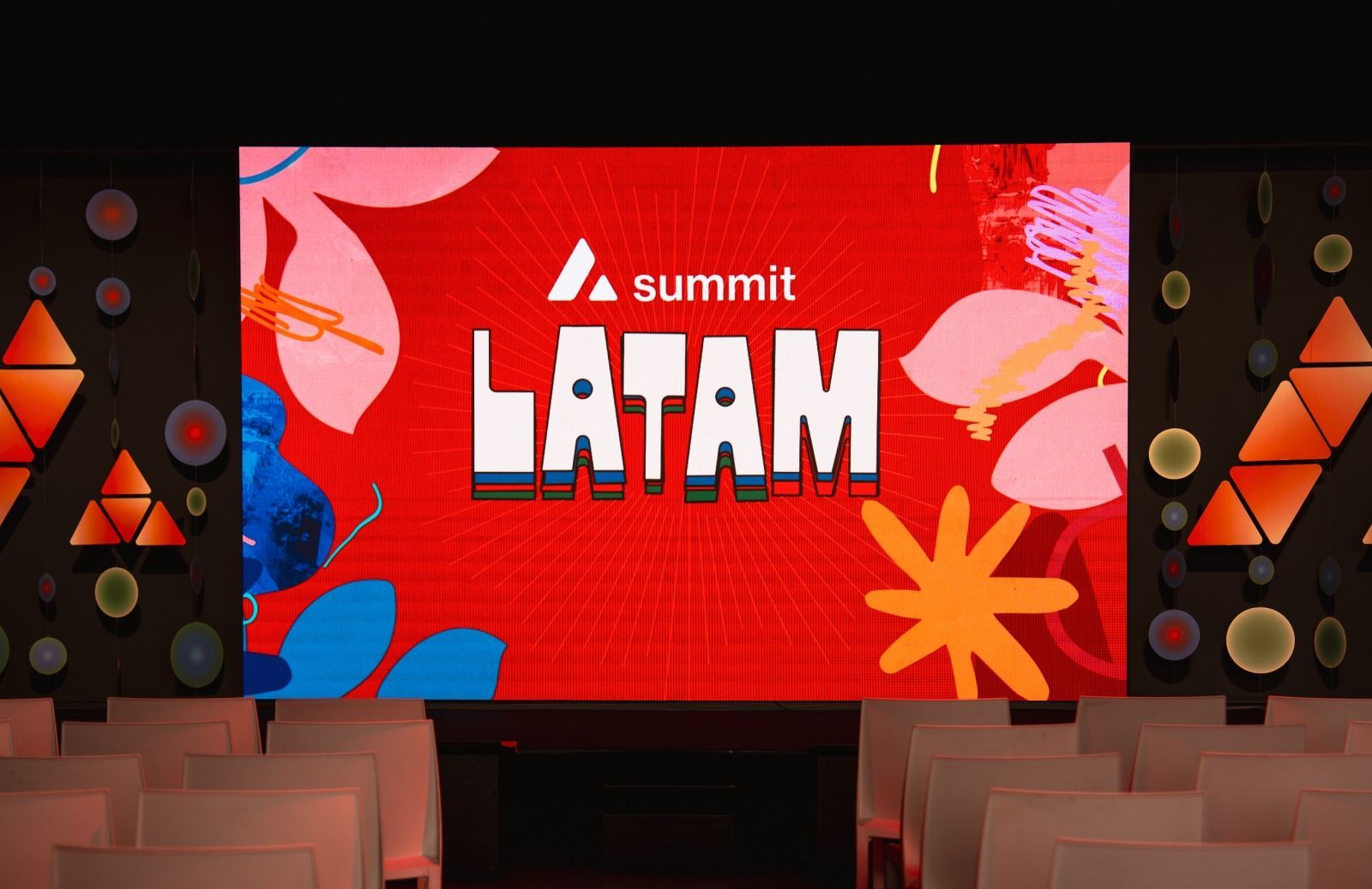 A stage with a large red screen displaying the text