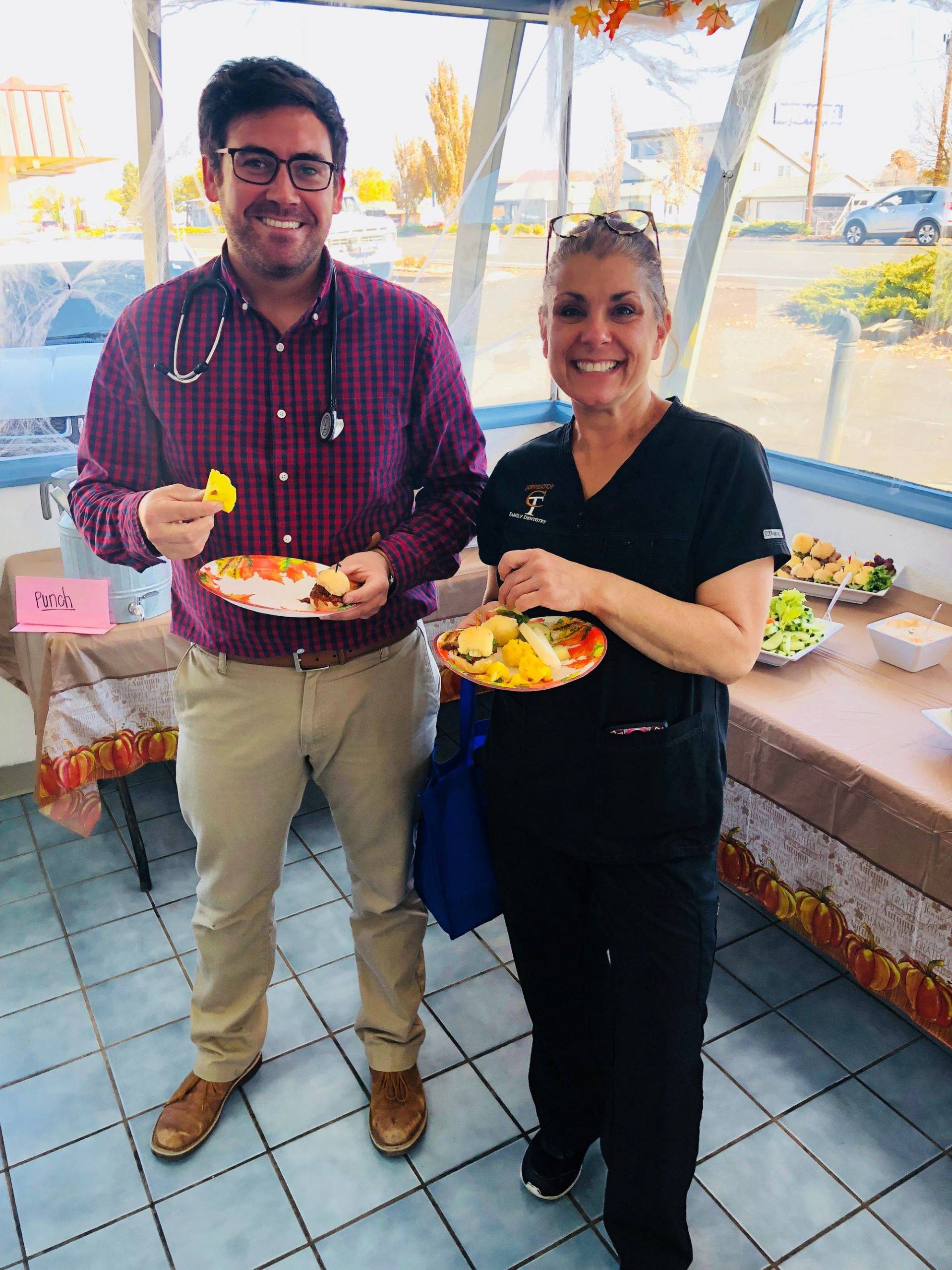 Doctor and Staff Holding Fruits — Redmond, OR — Rimrock Veterinary Clinic​​