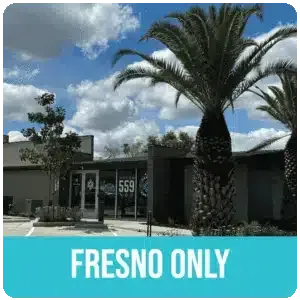 Building with palm trees and a sign that says 