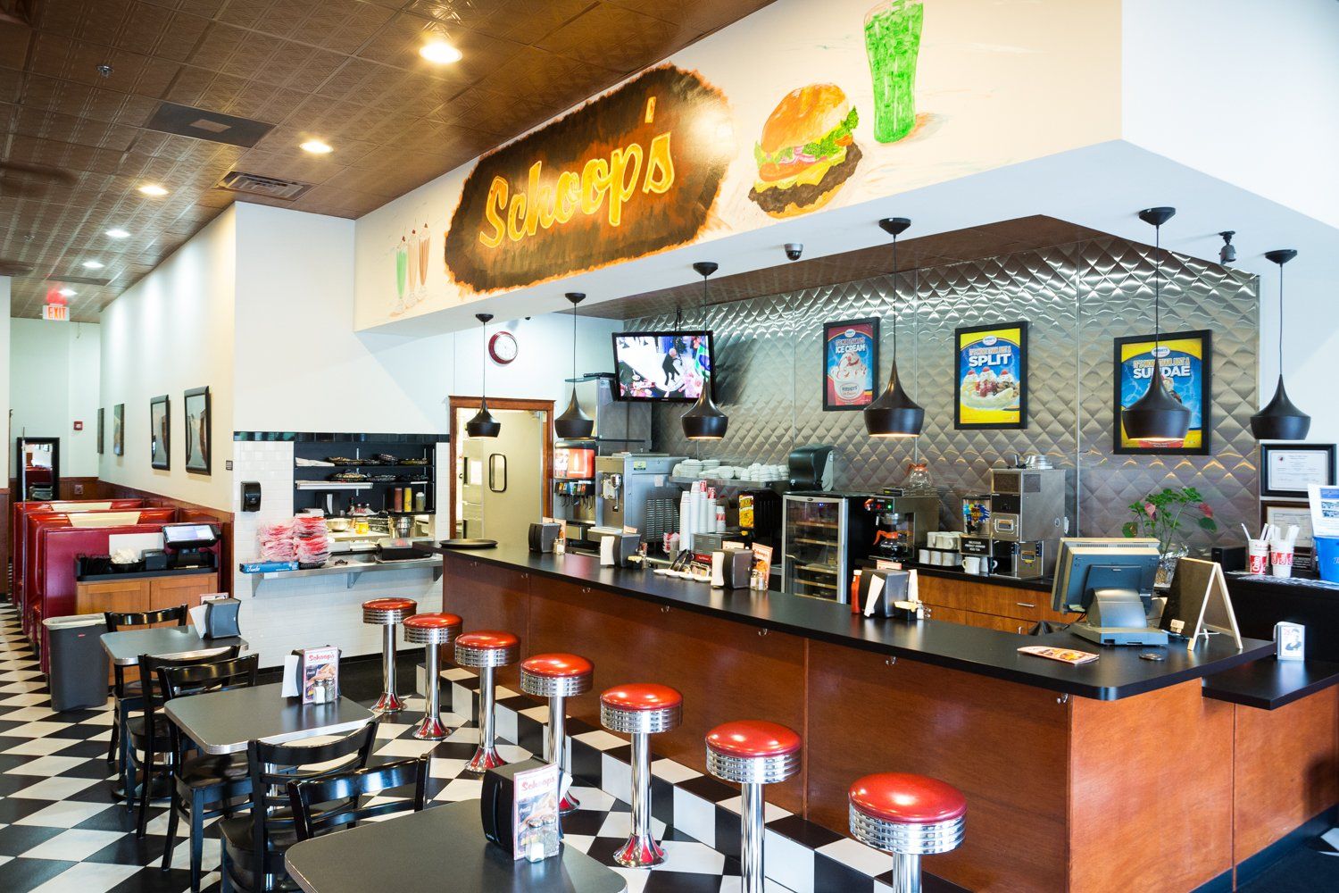 A diner with tables and chairs and a long counter.