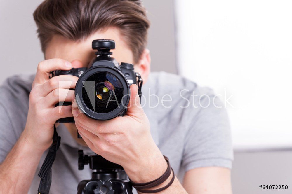 A man is taking a picture with a camera.