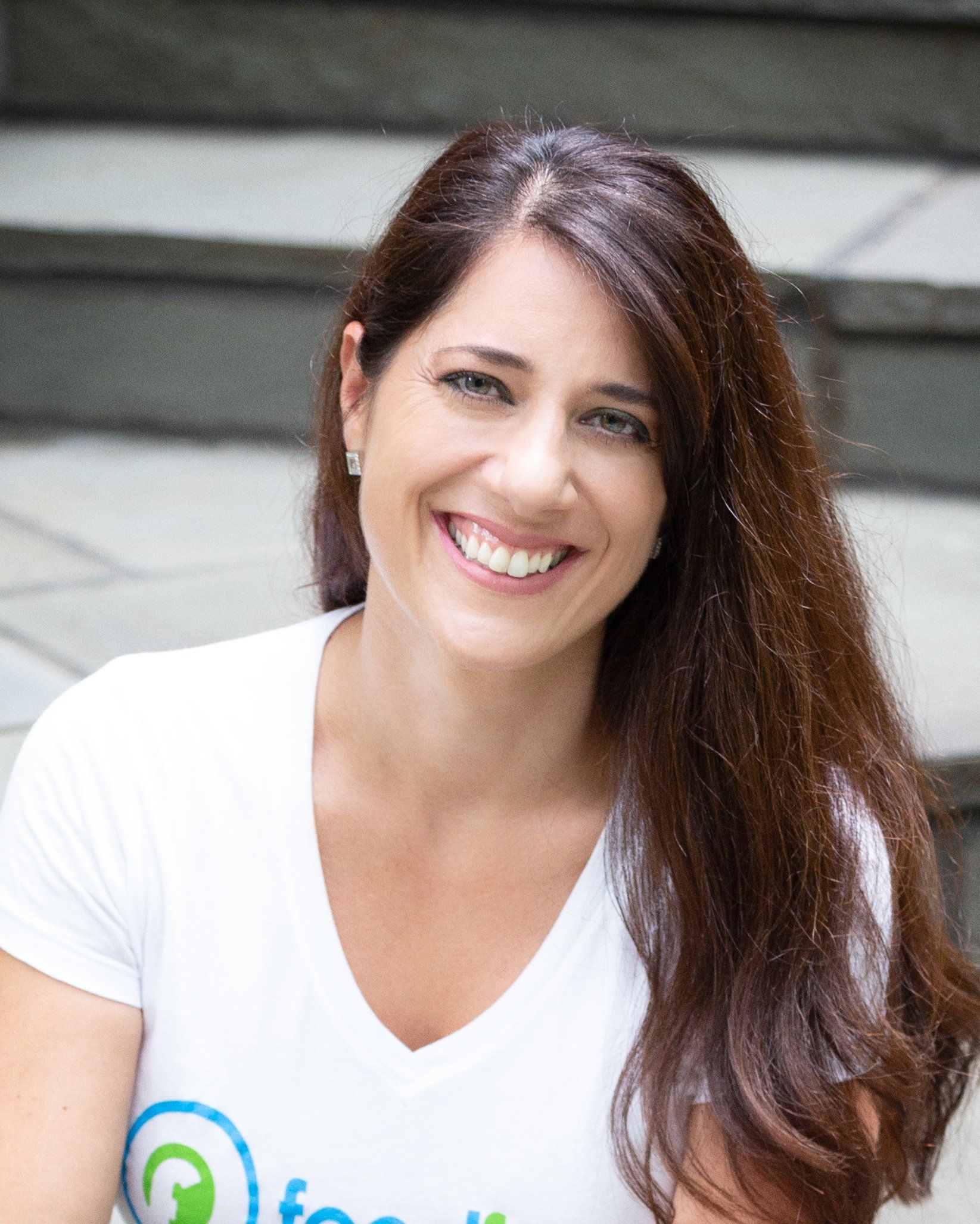 A woman wearing a white t-shirt with the word focus on it