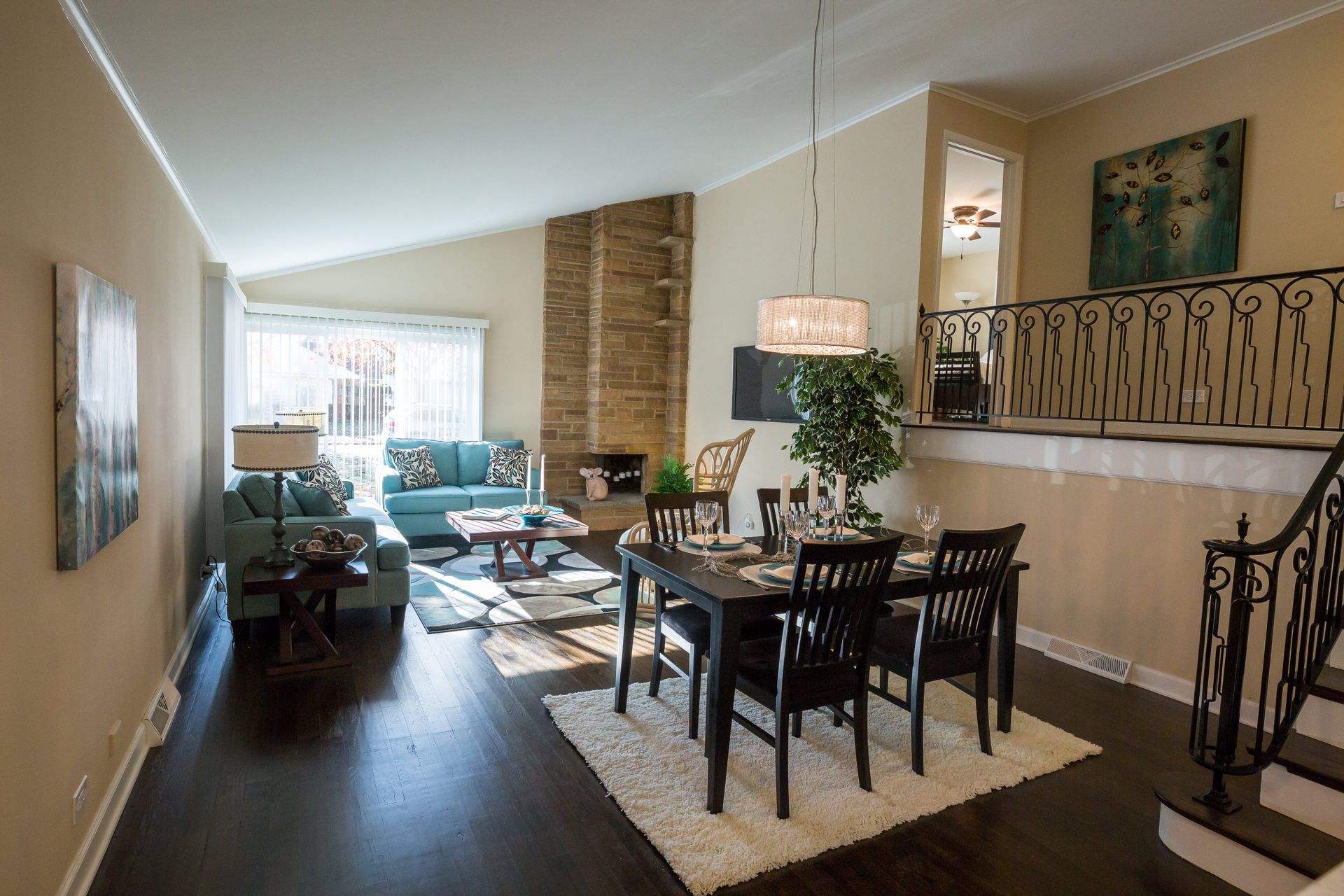 A living room with a table and chairs in it