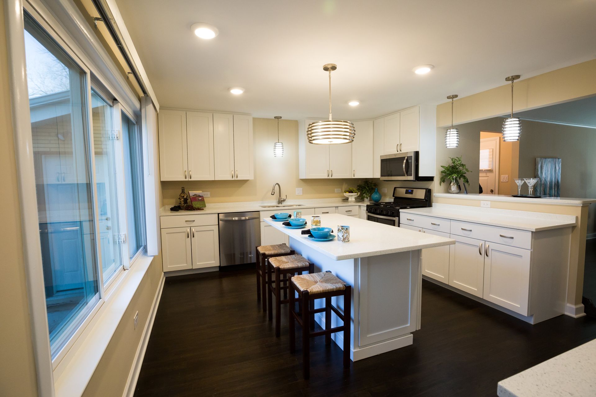 A kitchen with white cabinets and a large island