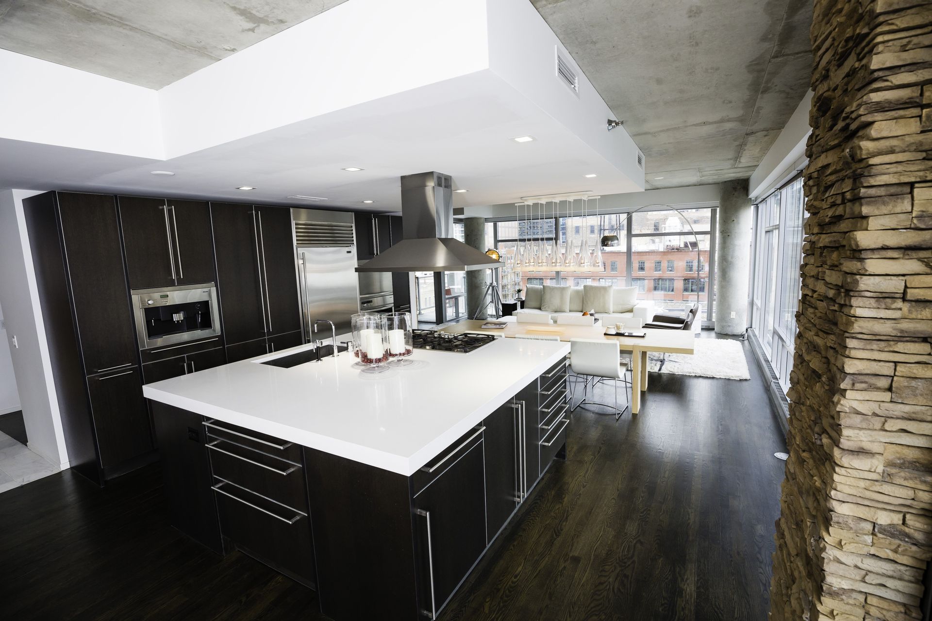 A kitchen with black cabinets and white counter tops