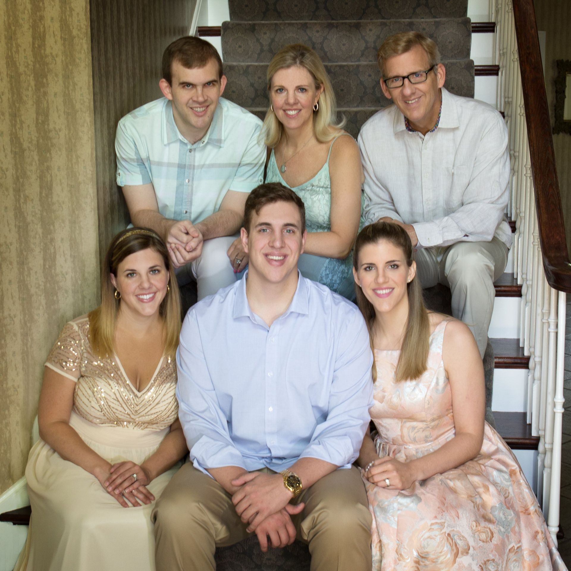A group of people are posing for a picture on a set of stairs