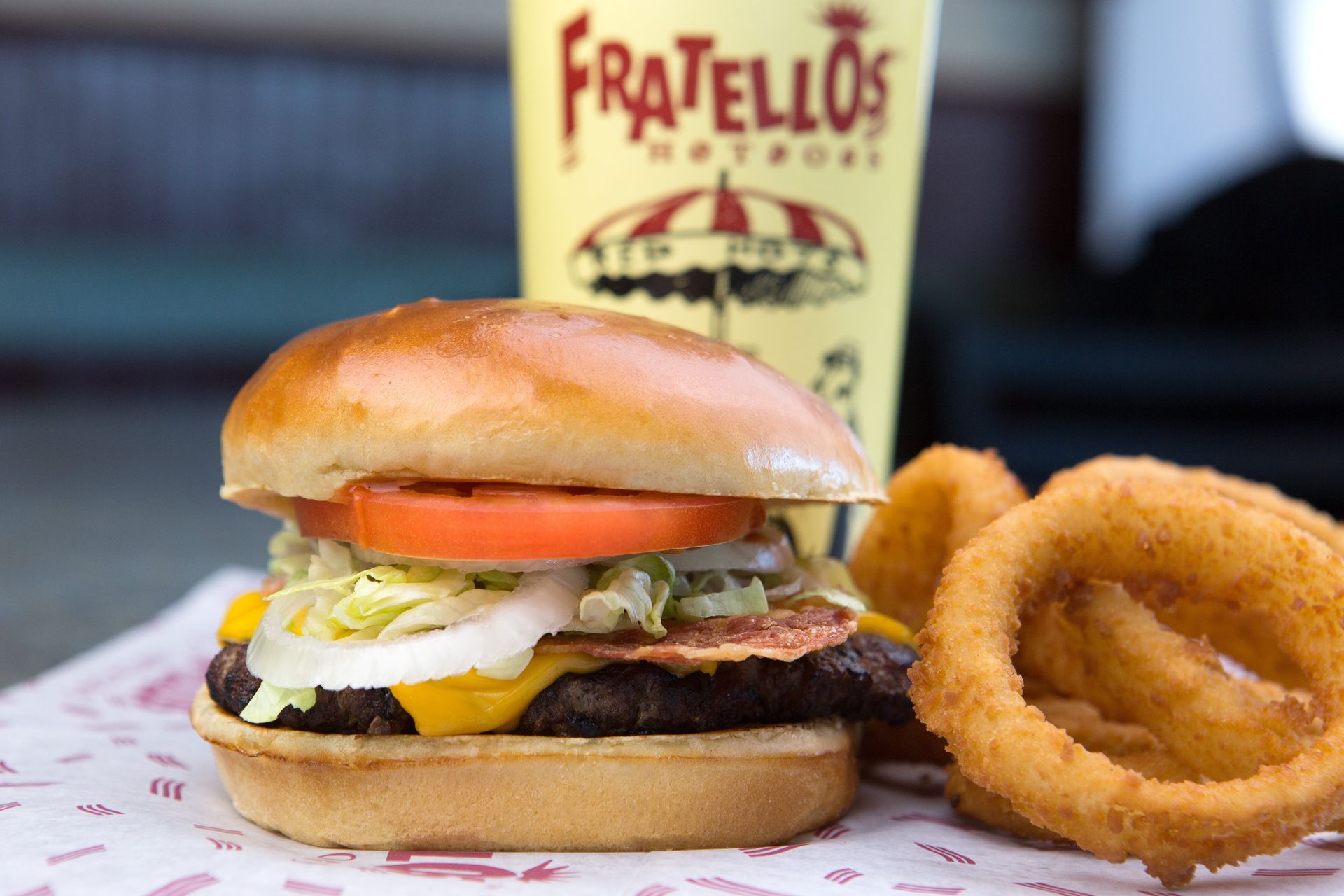 A fratello 's hamburger and onion rings on a table