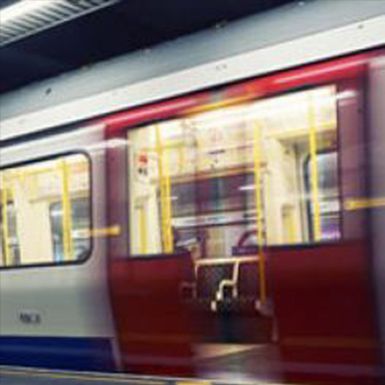 A red and white train is going down the tracks