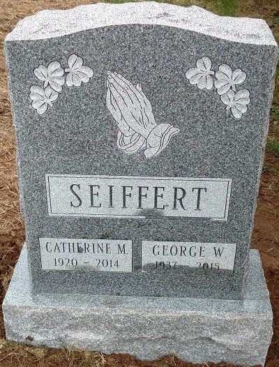 Headstone with praying hands, clover details, and names of Catherine and George Seiffert.