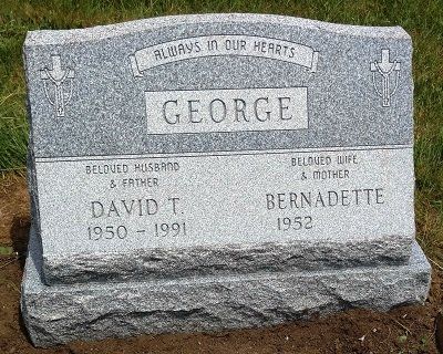 Granite headstone with the name George, and inscriptions for David T. (1950-1991) and Bernadette (1952).