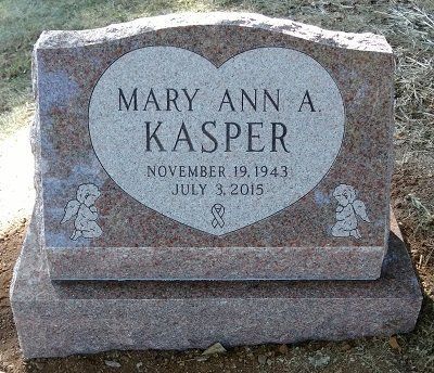 Grave marker for Mary Ann A. Kasper, red granite with heart-shaped inset, angels, dates November 19, 1943 - July 3, 2015.