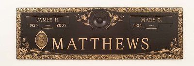Bronze grave marker with names James H. and Mary C. Matthews, with birth and death years.