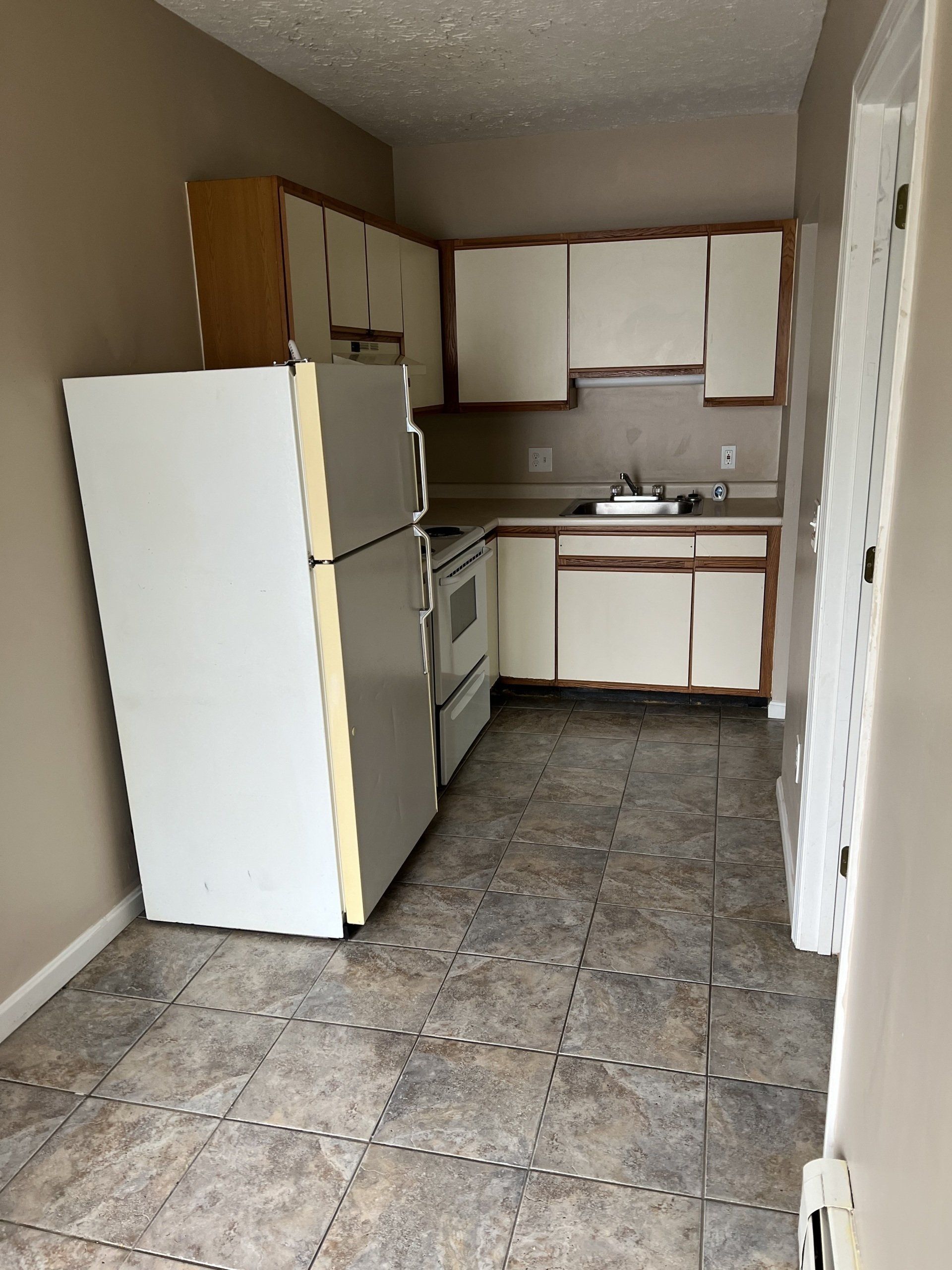 8 Church St. - Kitchen with stove and refrigerator