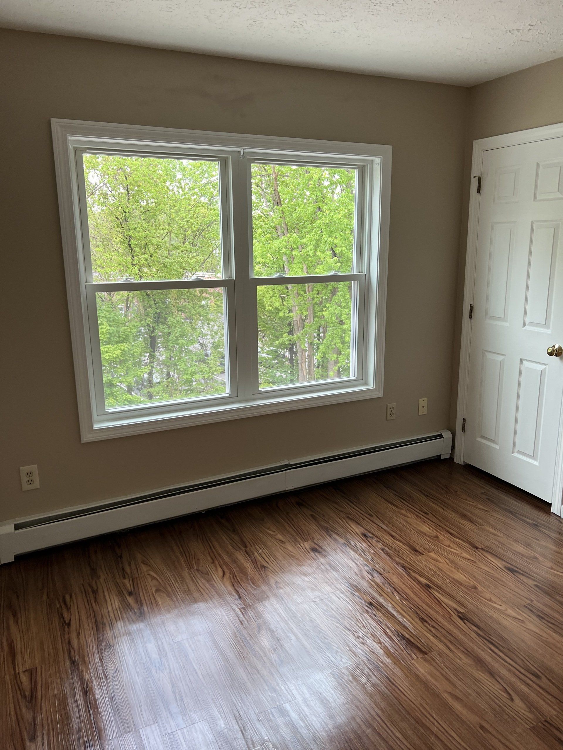 8c Church St. - bedroom with wood flooring and large window