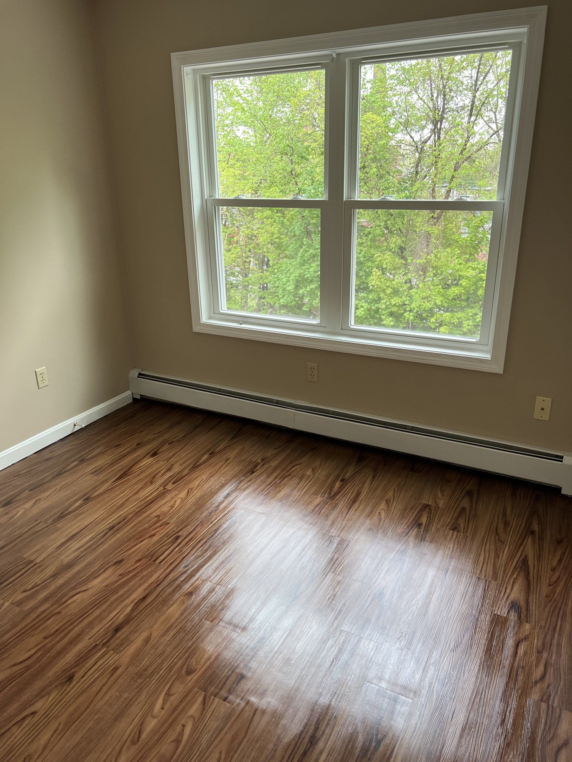 8c Church St. - bedroom with wood flooring and large window