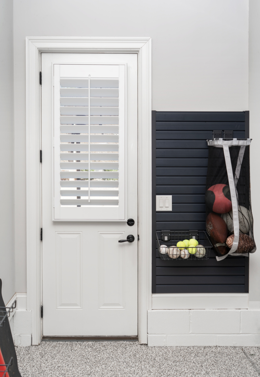 A white shutter on a half door in a garage