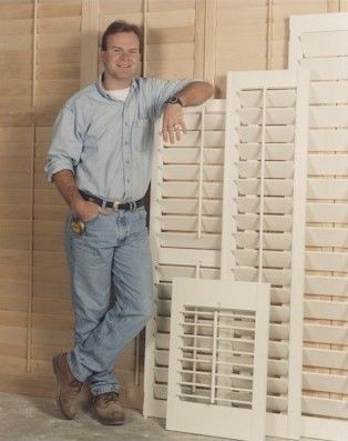 Factory man standing next to plantation shutters