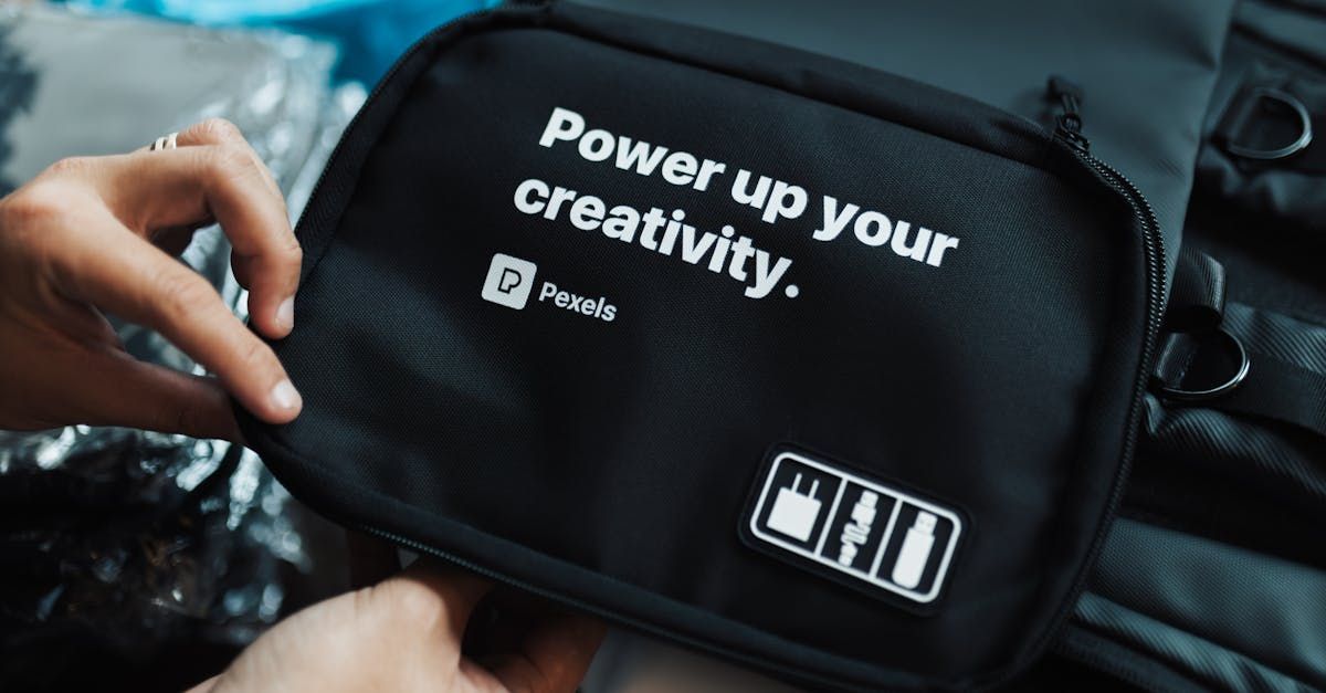 A person is holding a black bag that says `` power up your creativity ''.