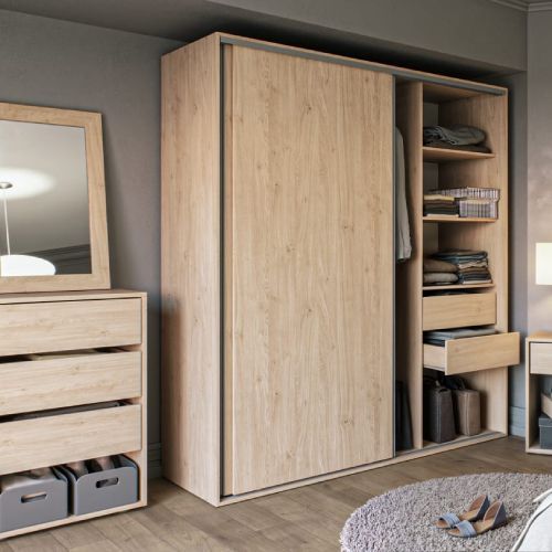 Armario de madera con puertas correderas que se abren para revelar estantes y una barra para colgar, junto a una cómoda.
