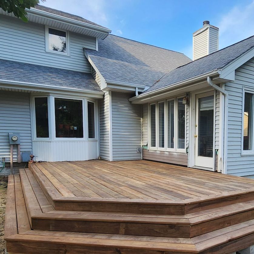 A house with a wooden deck in front of it