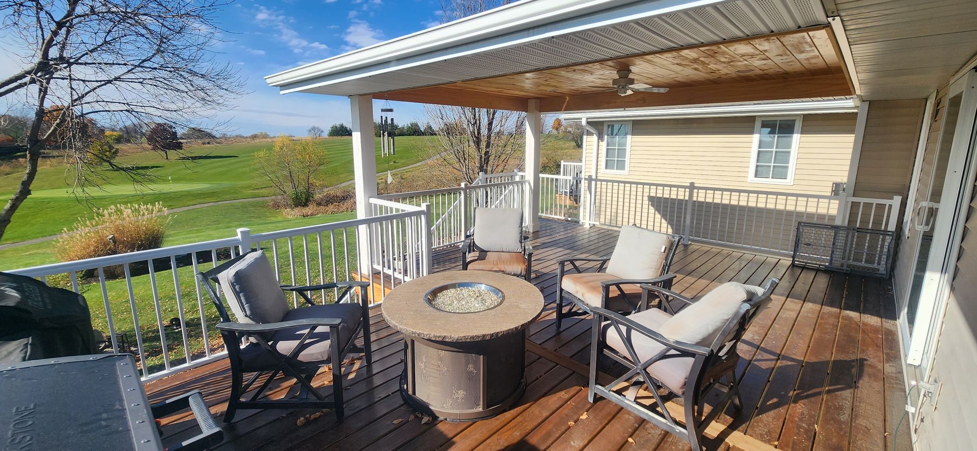 There is a fire pit on the deck of a house.