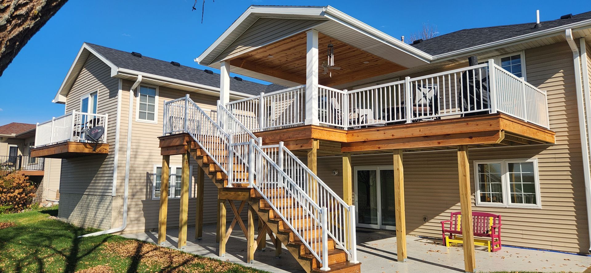 A house with a large deck and stairs leading up to it.