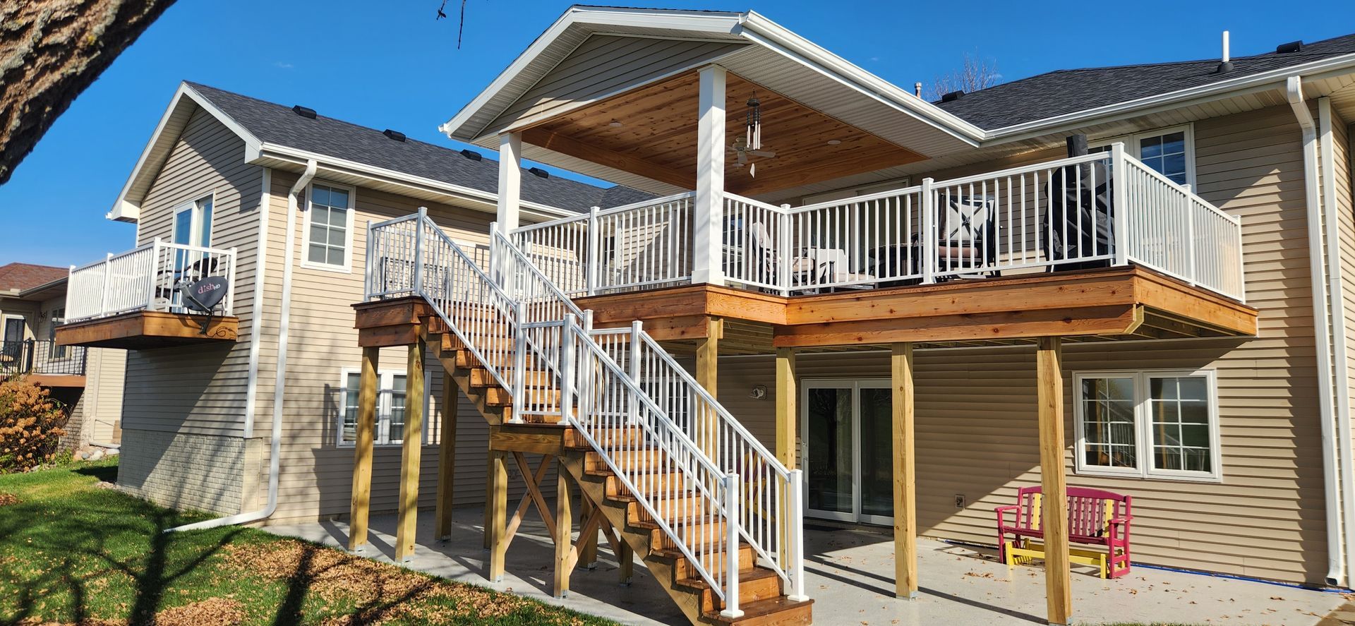 A house with a large deck and stairs leading up to it.