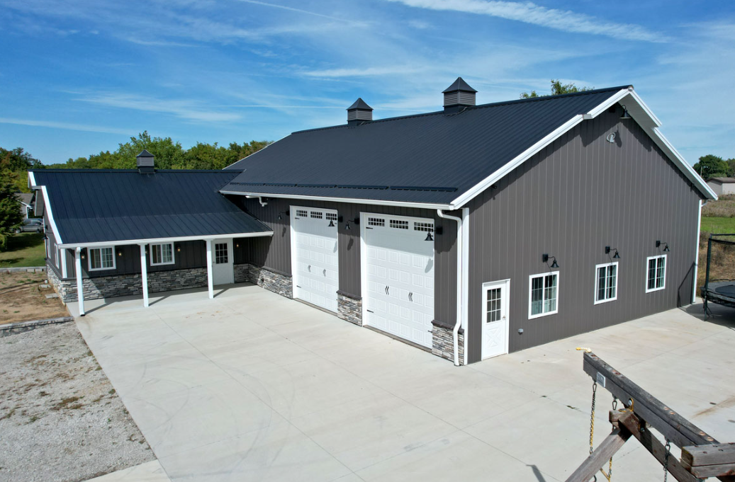 A large house with a garage and a car parked in front of it.