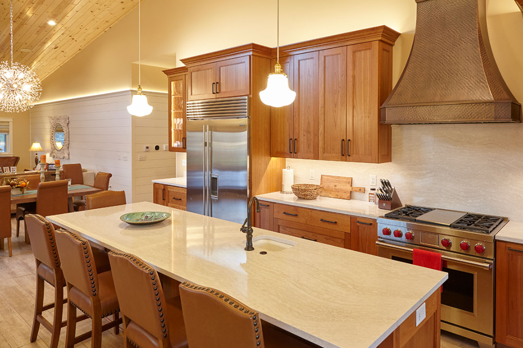 A kitchen with stainless steel appliances and wooden cabinets