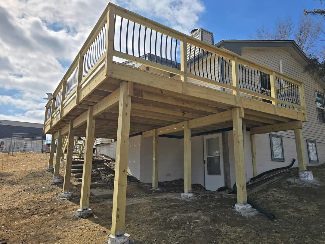 A wooden deck is being built on top of a house.