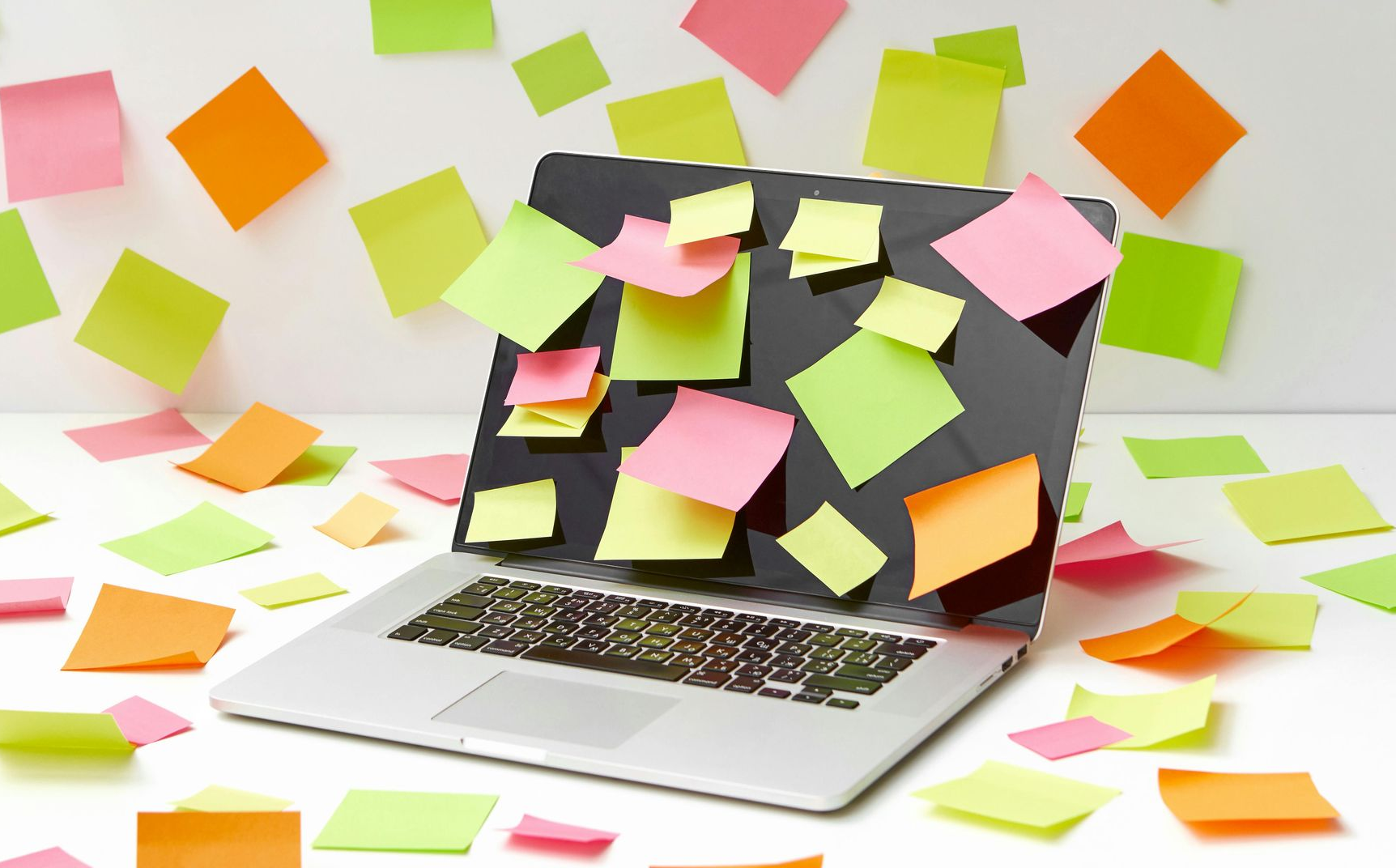 Laptop with many post it notes.